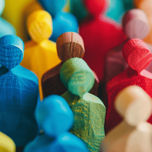 Business Education. Close-up of colorful wooden figures symbolizing diversity and inclusion within a community or organization.